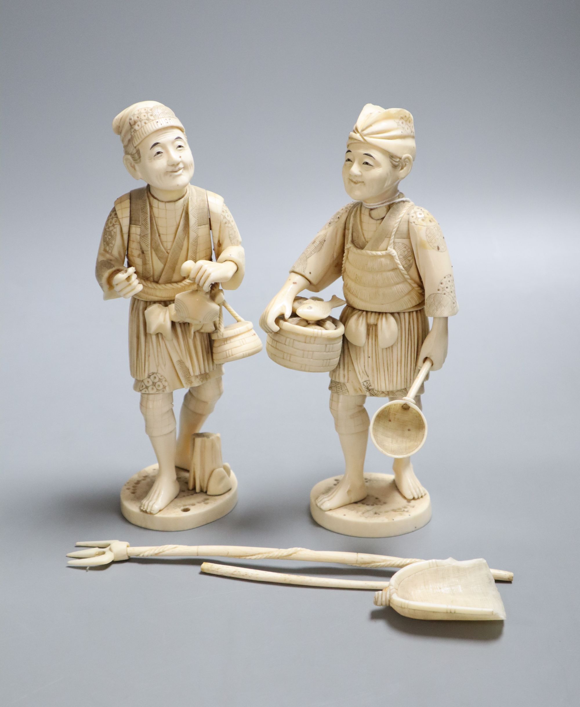 Two late 19th century Japanese okimono carved ivory figures of fishermen, height 19cm